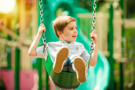 Baby boy having fun on a swing.の写真素材