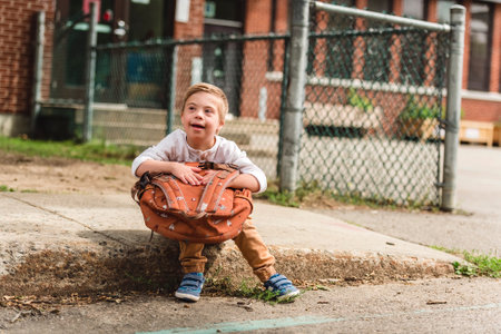 Portrait of a little schoolboy with down syndromeの写真素材