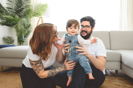 cute funny family wear white t-shirt playing with baby girl inside the living room