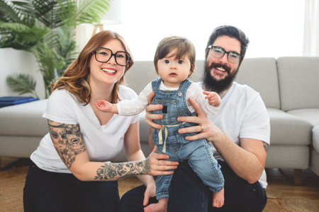 cute funny family wear white t-shirt playing with baby girl inside the living roomの写真素材