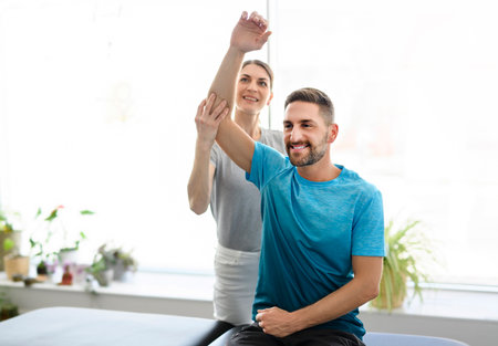 Modern rehabilitation physiotherapy woman worker with man client