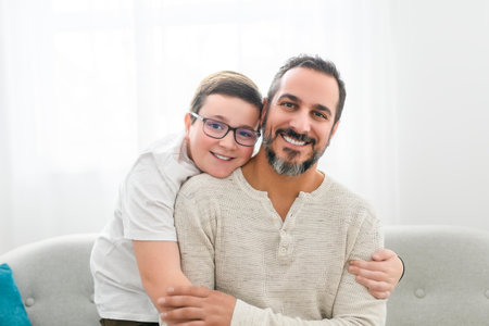 father and boy having great time on sofa at home