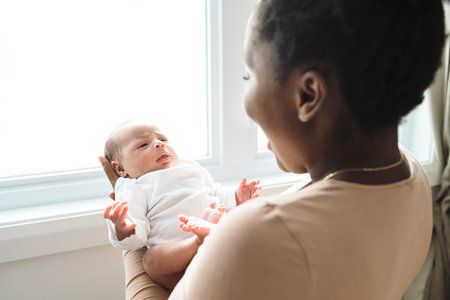 A Portrait of a beautiful black mother, with her nursing baby
