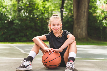 girl with basketball on court on summer season