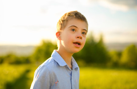 Portrait of a little boy having fun at the sunset timeの写真素材