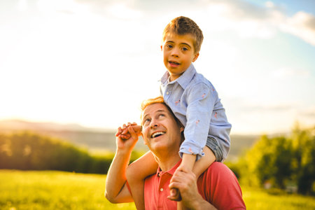 Nice father and child Playing on great field at Sunsetの写真素材