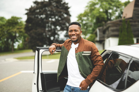 young black man with his new car