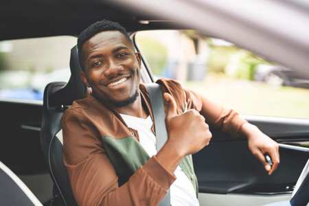 young black man with his new car