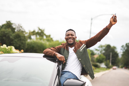young black man with his new car