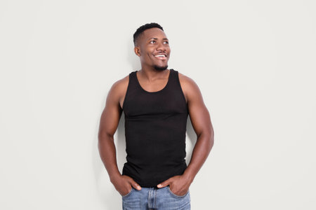 Male black wearing dark tanktop on ripped muscular torso in studio shot on white background