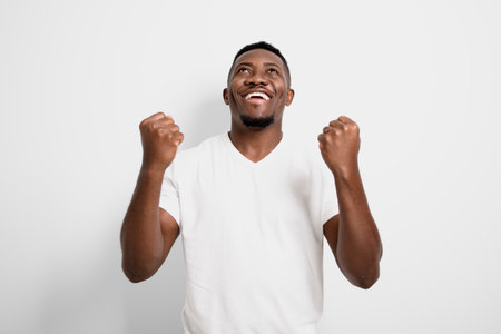 Black men wearing white shirt in studio shot on white backgroundの写真素材