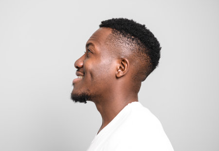 Black men wearing white shirt in studio shot on white backgroundの写真素材