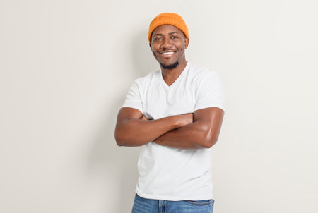 black man confident and casual on white background wearing hat