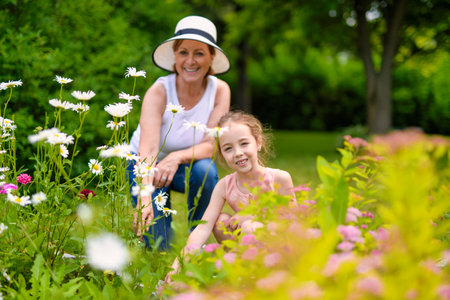 grandmother and granddaughter in the gardenの写真素材