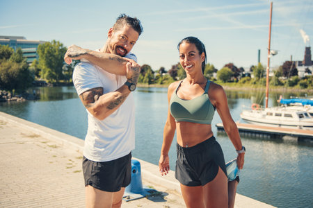 Young fitness couple running on a city on summer day