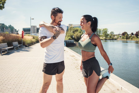 Young fitness couple running on a city on summer dayの写真素材
