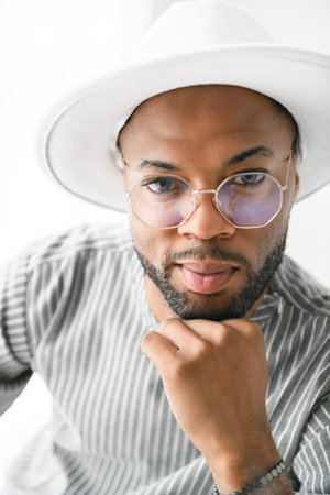 Portrait of black fashion American wearing great looking clothes with white hat