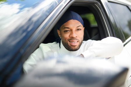 portrait of happy black american man driving car