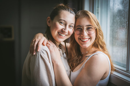 Happy couple cuddling at home. Romantic young LGBTQの写真素材