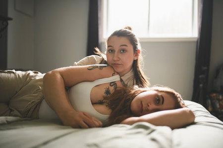 Happy couple having great time close to a window at homeの写真素材