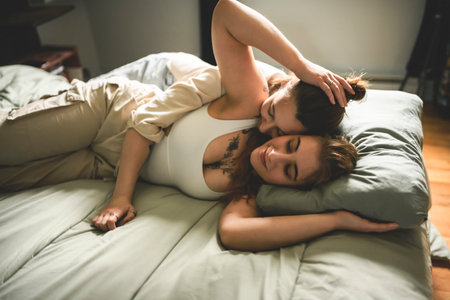 Happy couple having great time close to a window at home