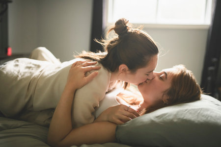 Happy couple having great time close to a window at home