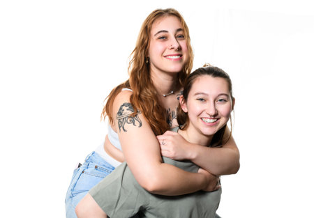 Happy lesbian couple on studio white background.の写真素材