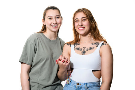 Happy lesbian couple on studio white background.の写真素材