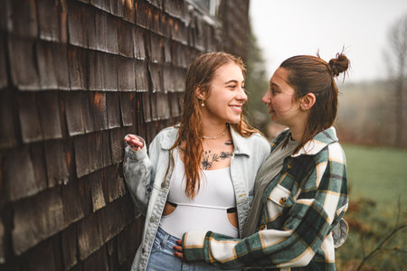 Lesbian Couple Together Outdoors in a rainy dayの写真素材