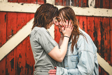 Lesbian Couple Together Outdoors in a rainy dayの写真素材
