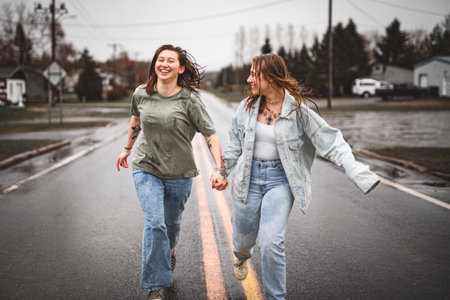 Lesbian Couple Together Outdoors in a rainy day