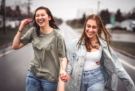 Lesbian Couple Together Outdoors in a rainy day