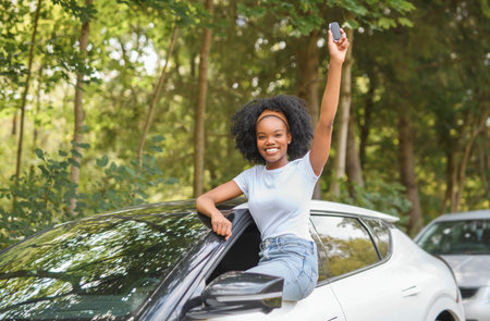 Young black teenage driver in her new car