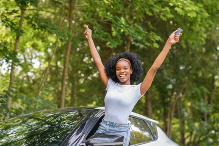 Young black teenage driver in her new car