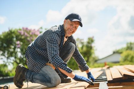 Handyman worker making patio outside close to a pool.