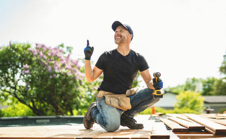 Handyman worker making patio outside close to a poolの写真素材