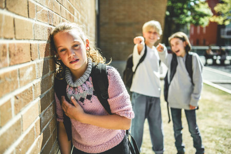 sad girl Bullying in Schoolyard by two friends