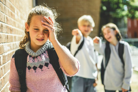 sad girl Bullying in Schoolyard by two friends