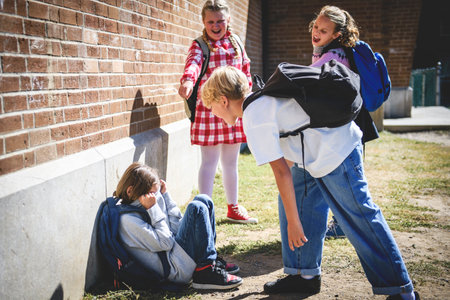 sad moment Elementary Age Bullying in Schoolyard. childs bully child boyの写真素材