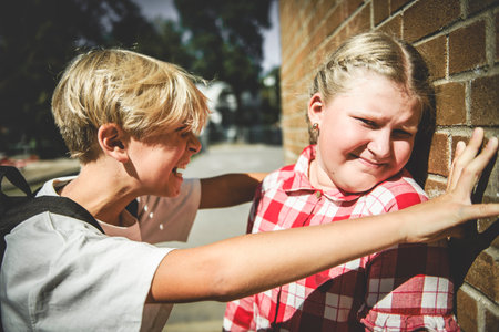 sad moment Elementary Age Bullying in Schoolyardの写真素材