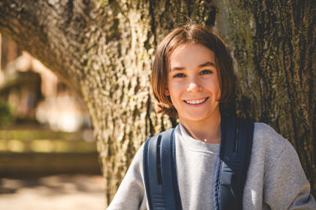 child boy Smiling And Leaning Against Tree