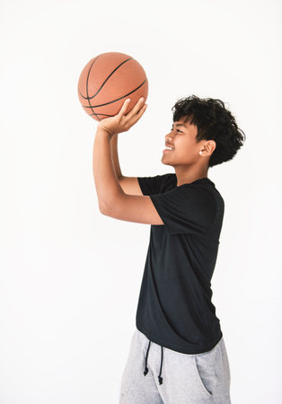 teens in sportswear playing basketball game on studio white backgroundの写真素材