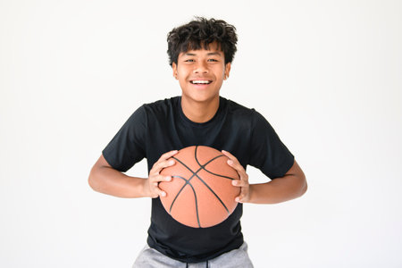 teens in sportswear playing basketball game on studio white backgroundの写真素材