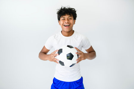 nice Boy with soccer ball on studio white background