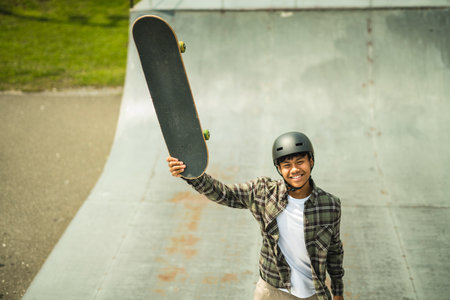 nice Boy with skateboards outside on skate playground