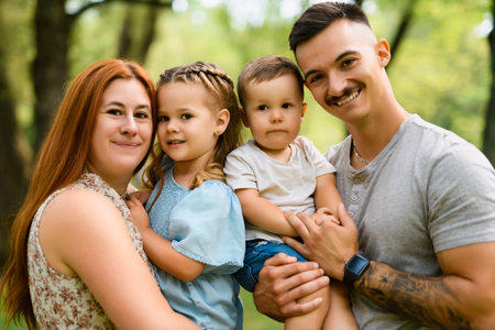 Beautiful happy family enjoying in the parkの写真素材