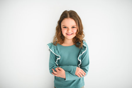 Portrait of a cute 6 or 7 years old girl over white backgroundの写真素材
