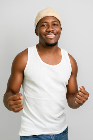 Men wearing white tanktop on ripped muscular torso in studio shot on white backgroundの写真素材