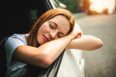 Beautiful young girl driver with with her white carの写真素材
