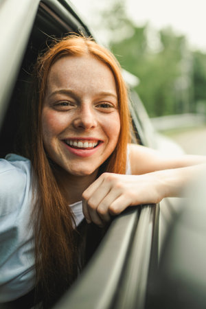 Beautiful young girl driver with with her white carの写真素材